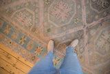 Distressed Soumac carpet featuring playful dusty rose borders and sky blue wave motif.