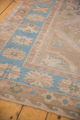 Vintage Caucasian Soumac carpet's sky blue border with dusty rose geometric blossoms and zig-zag pattern.