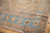 Softened tones on vintage Soumac carpet's sky blue floral and geometric border patterns.