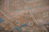 Distressed Soumac carpet pile showing dusty rose and blue geometric patterns with reverse.