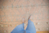 Vintage distressed Oushak rug with rose, silver tree of life motif, and even wear.