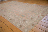 Distressed Oushak corner with rose tree of life vinery and playful geometric borders.