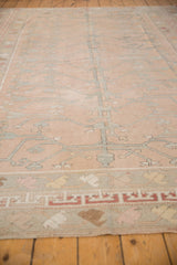 Distressed rose Oushak rug showing silvery tree of life motif and wide banded borders.