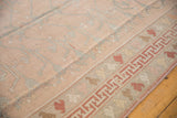 Distressed vintage Oushak carpet showing rose tree-of-life motif and playful cochineal geometric border.