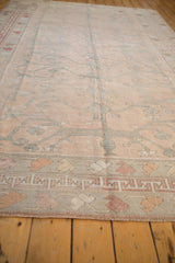 Distressed vintage Oushak carpet border with cochineal red geometric and playful pale tangerine motifs.