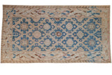 Vintage distressed hand woven Soumac carpet, indigo blue medallions, beige field, wave borders.