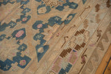 Vintage Soumac carpet detail with beige-blue geometric field and serrated wave borders.