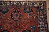 Antique Malayer rug corner showing madder red Harshang field, intricate vine border, and colorful botehs.