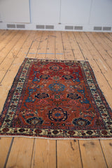 Antique Malayer rug: cherry red Harshang field, sapphire, blush floral motifs, boteh borders.