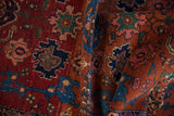 Textured pile of antique Malayer rug with intricate floral motifs in deep red, sapphire blue, and blush.