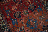 Antique Malayer rug's Harshang field with madder red, sapphire blue motifs, showing minor pile wear.