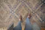 Vintage Distressed Soumac carpet, geometric lattice pattern in soft beige and blue with abrashes.