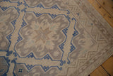 Flatweave texture of a distressed Soumac rug, with cobalt blue geometric lattice and subtle florals.