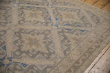 Vintage Soumac rug showcasing geometric lattice, textured weave, and cobalt blue medallion outlines.