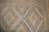 Soumac carpet detail with beige, cobalt, and mauve multi-medallion patterns, showing abrashes.