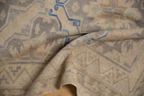 Detail of the vintage distressed Soumac rug, showing geometric patterns, abrash, beige, and pale blue.