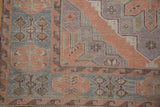 Detailed view of geometric motifs in dusty blush, powder blue, and mauve Soumac weave.