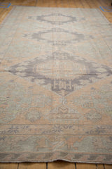 Outermost border of a vintage distressed Soumac carpet with a reciprocating wave motif.