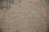 Textured flatweave of a distressed Soumac carpet, with geometric patterns in beige and slate.