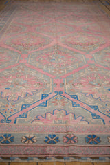 A low-angle view highlights the hexagonal medallions of a distressed pink and blue Soumac runner.