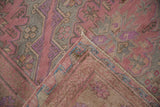 Folded corner of a vintage Caucasian Soumac rug showing the hand woven flatweave texture and reverse side.
