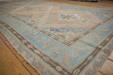 Distressed vintage Soumac rug runner border featuring light blue bird and plant motifs.