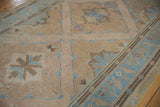 Distressed Soumac rug with textured light blue main border and beige bird motifs.