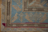 Detailed view of hand-woven Soumac border with geometric birds, plant motifs, blue and earth tones.