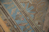 Distressed vintage Soumac runner detail showing geometric bird and plant motifs in blue and brown.