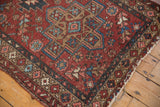 Distressed vintage Mehrivan rug with a stepped geometric medallion in red, blue, and beige.