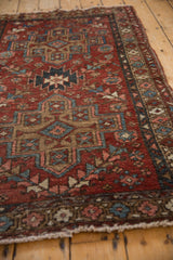 Distressed texture and geometric-floral patterns of the vintage Persian Mehrivan rug.