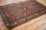 Vintage Mehrivan rug corner with aged texture, intact selvage, and floral borders.