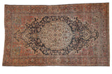Distressed Farahan Sarouk rug: ivory medallion, blush field, and navy floral patterns.