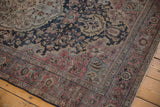 Distressed Farahan Sarouk rug corner featuring blush, navy, ivory floral vinery and texture.
