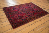 Vintage American Sarouk rug corner with raspberry field, thousand flower motif, and indigo border.