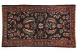 Vintage Persian Bibikabad rug with navy blue field, oversized Herati floral pattern, and burgundy border.