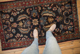 Dramatic Herati-inspired floral blossoms and serrated leaves on the vintage Bibikabad rug.