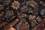 Folded detail of vintage Bibikabad rug showing navy and burgundy Herati-like motifs.