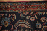 Vintage Bibikabad close-up: navy blue field with oversized floral blossoms, serrated leaves, and wear.