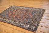 Vintage Malayer rug corner detail, highlighting meandering vine and intricate pawn motif borders.
