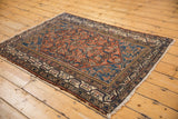 Vintage Malayer rug corner, showing intricate ivory and indigo pawn motif border.