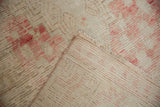 Hand-knotted Oushak runner close-up showing distressed ivory and blush pile, visible foundation, and fringe.