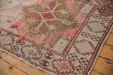 Distressed vintage Oushak runner corner, checkered floral guls, pinwheels, blush, and bronze.