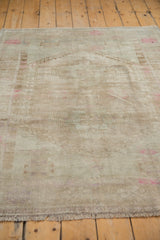 Distressed soft pile of the vintage Oushak rug with subtle tone-on-tone colors and pink accents.