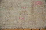Close-up of the distressed Oushak rug's soft oxidized silver pile with faded pink tones.