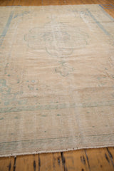 Worn pile and distressed texture of vintage Oushak, with isolated foundation and pale blue.