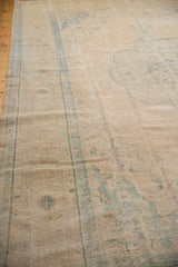 Faded ivory and pale denim blue motifs on a vintage distressed Oushak carpet surface.