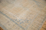 Textured pile and original side cord selvage of a distressed vintage Oushak carpet.
