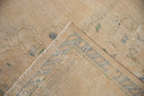 Distressed Oushak carpet pile in ivory, pale blue, green showing worn texture and reverse.