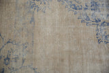 Mostly even wear across the knot heads on a distressed vintage Oushak carpet in ivory and blue.